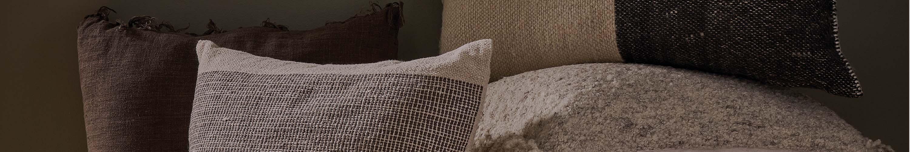 Decorative throw pillows in a pile